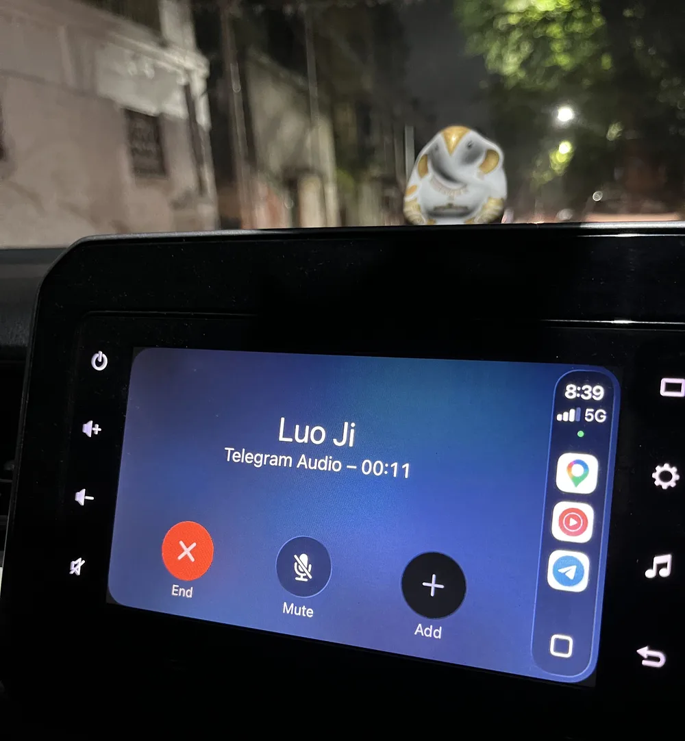 My car's dashboard screen at night, showing a Telegram audio call with Luo Ji, eleven seconds in, with End, Mute and Add buttons.